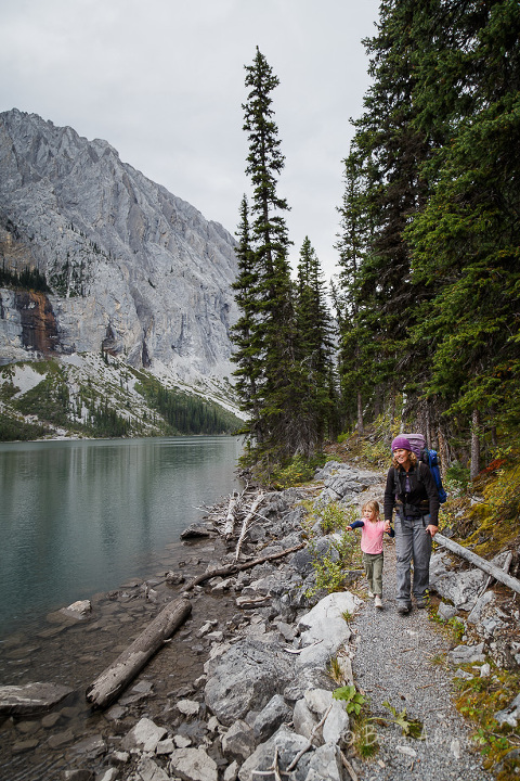 Mother and small child hiking hand in hand at Upper Elk Lake