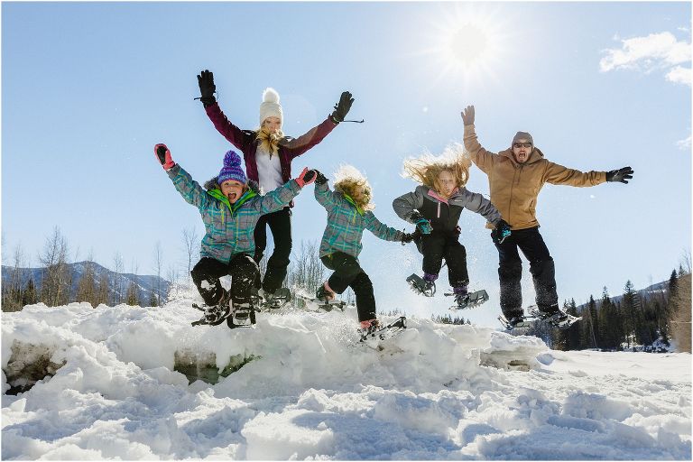 family jumping snowshoes